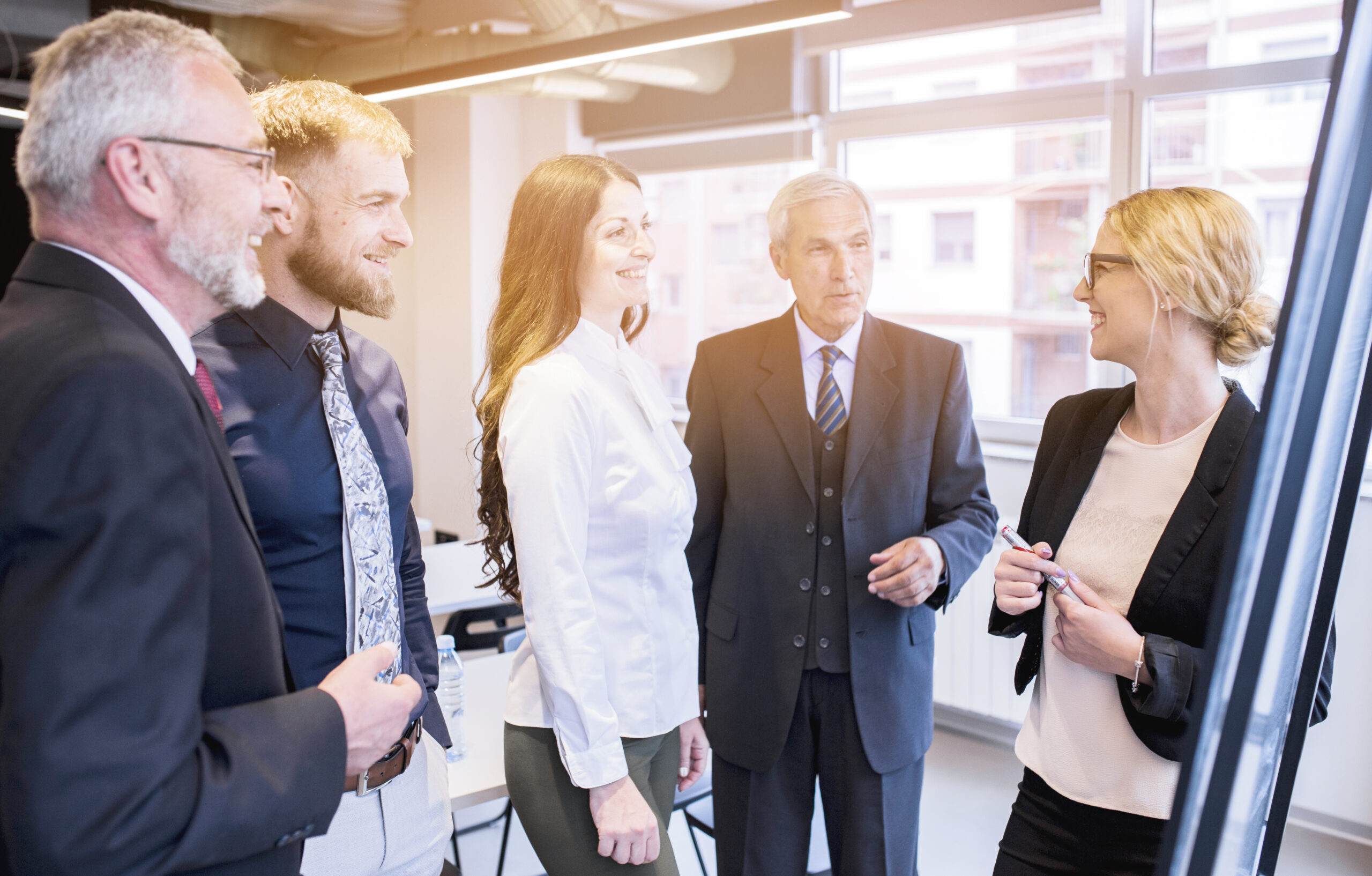 group-business-colleagues-looking-young-businesswoman-giving-presentation